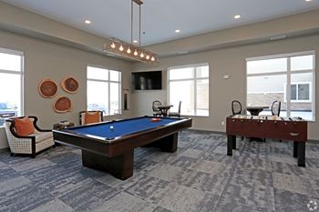 game room with pool table and fuse ball tableat SoRoc On Maine, Rochester Minnesota